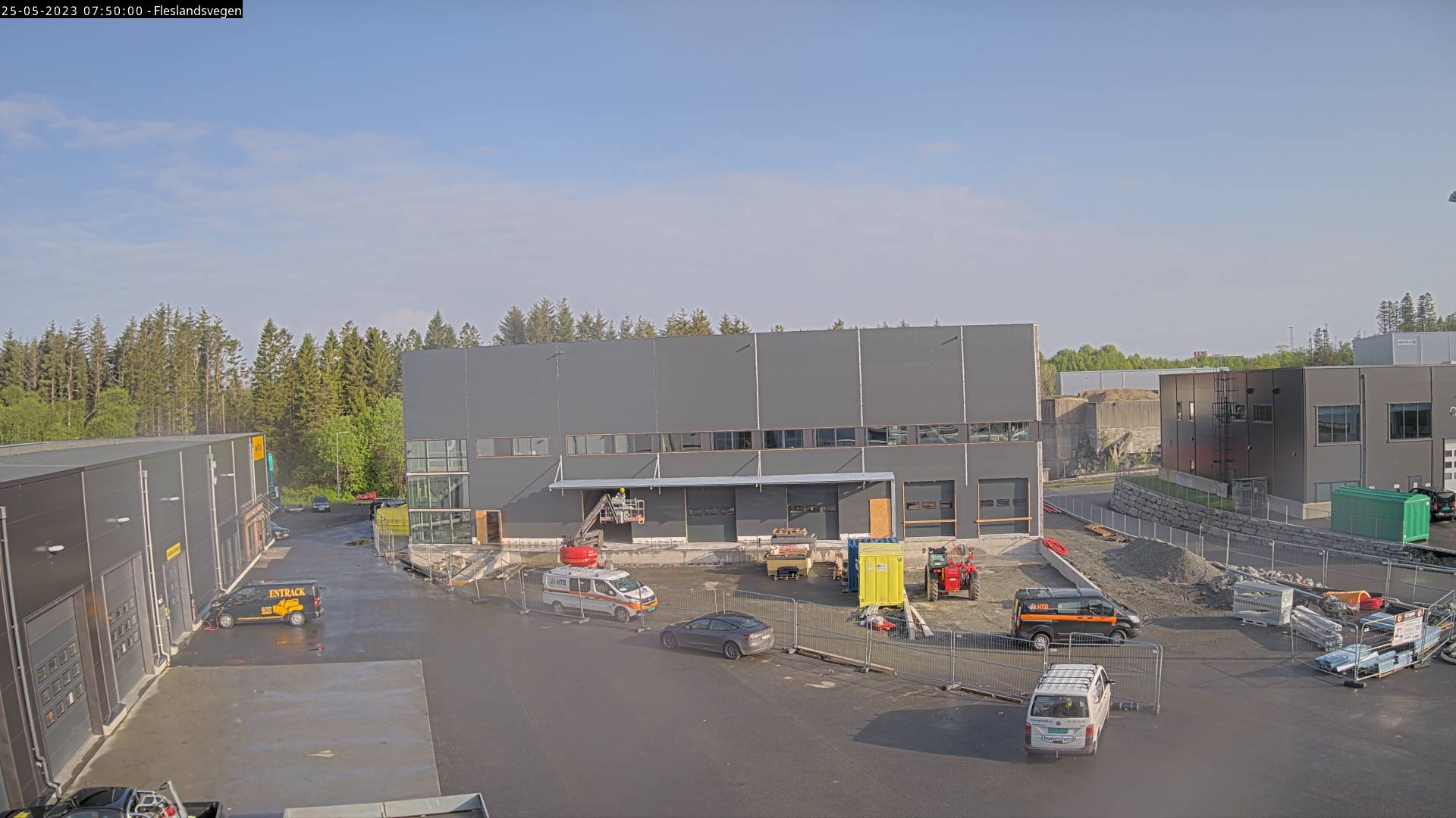 Image showing a new warehouse. The new building is grey with a row of windows.